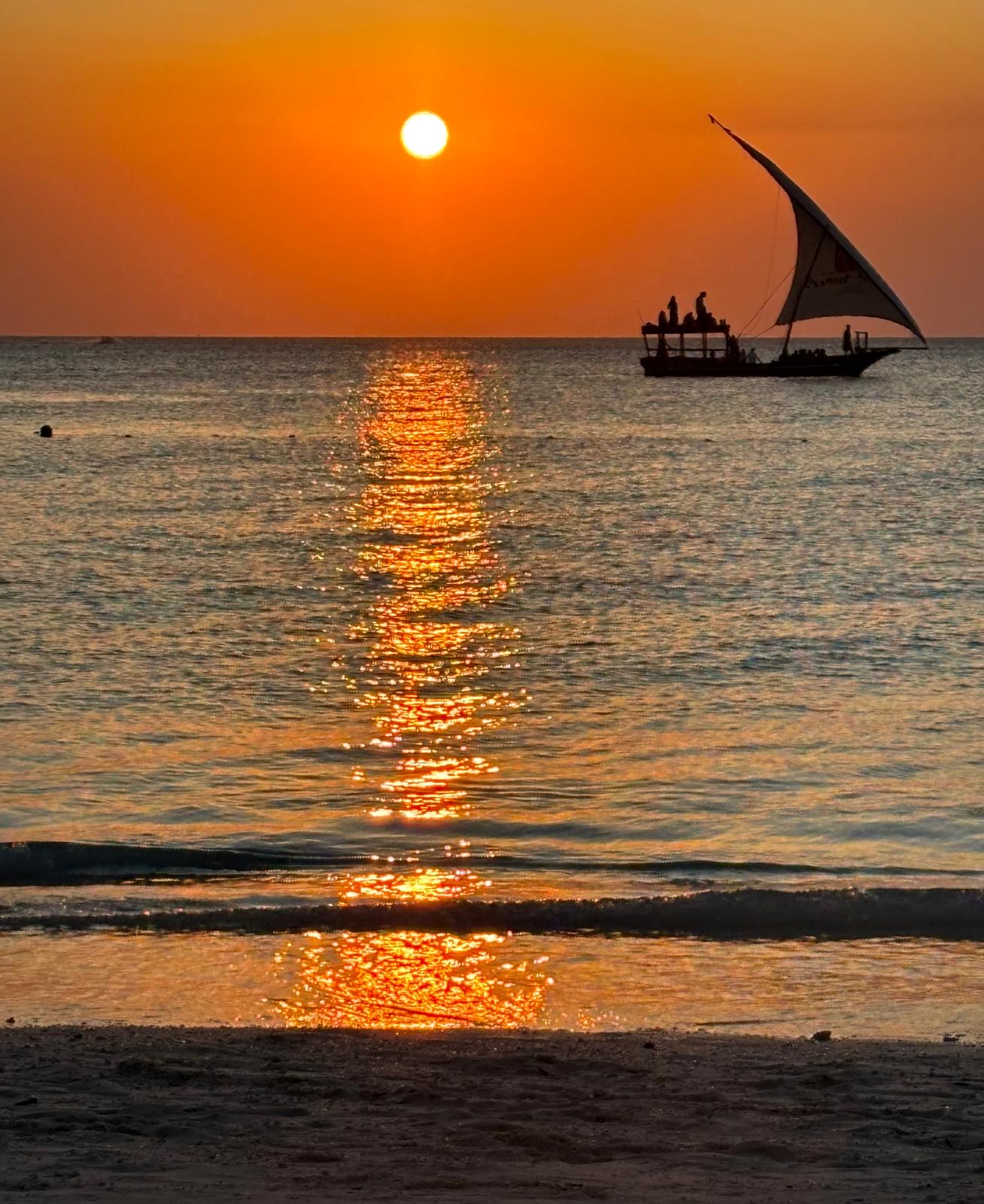 Zanzibar dhow on turquoise water at sunset
